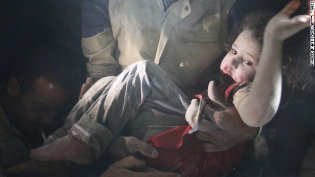 A rescue worker pulls a girl from rubble in Aleppo on June 1 after reported bombing by government forces.