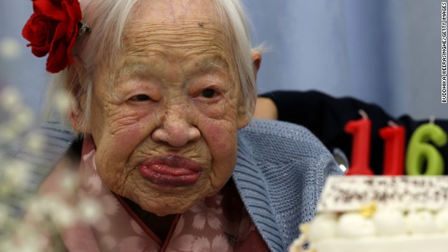 The oldest living woman alive is Misao Okawa, a 116-year-old from Japan. She was born March 5, 1898, and had three children. Her husband died in 1931. She kept in shape throughout much of her life. At 102, she said she did leg squats to keep healthy. She didn't start using a wheelchair until she turned 110. She currently lives in a nursing home.