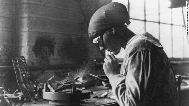 A female munitions worker welds at an armaments factory.