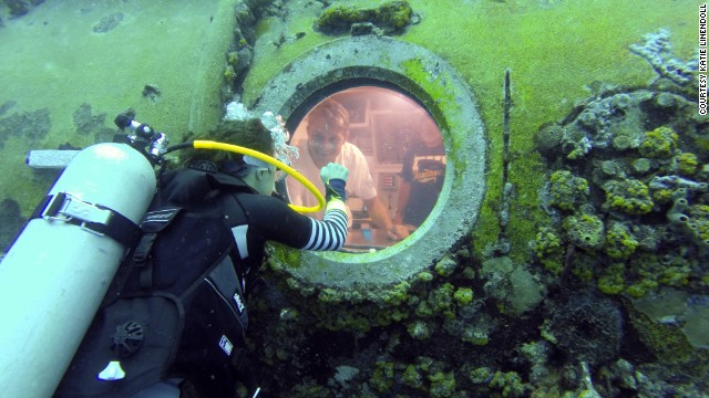 At 400 square feet, the Aquarius lab is the size of a small studio apartment. Here Cousteau, grandson of famed oceanographer Jacques Cousteau, peers out a viewport. 