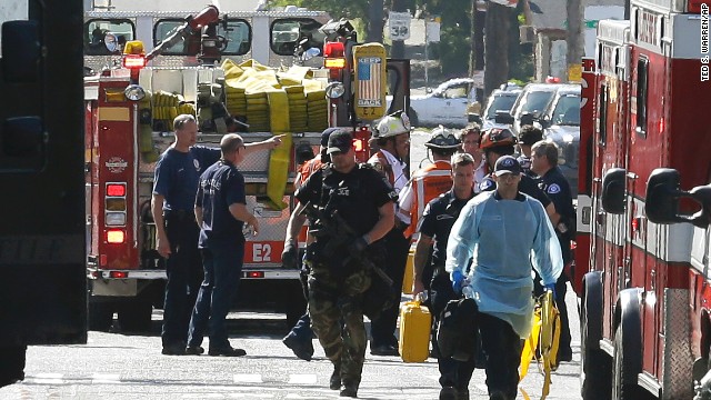 Medical and police officers gather at the scene.