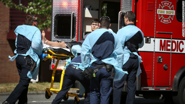 Jon Meis, the student credited with dousing the gunman with pepper spray and tackling him, is loaded into an ambulance after the incident.