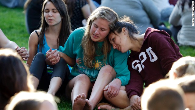 Students gather in a prayer circle June 5 after a church service was full.