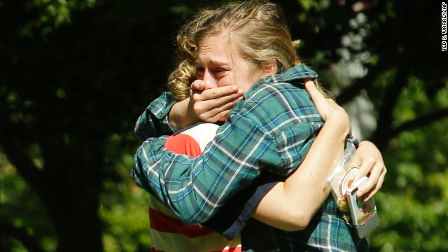 Two women embrace near a prayer circle Friday, June 6, on the campus of Seattle Pacific University. A day earlier, a gunman entered the school's science and engineering building, shot three people and was reloading a shotgun when a student subdued him, police said.