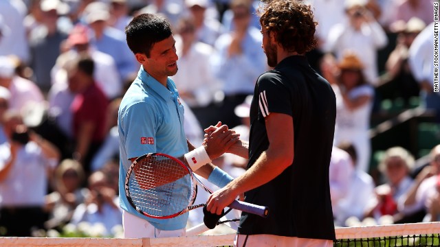 Djokovic and Gulbis embrace at the end of the match at a sun kissed Roland Garros. Djokovic will now aim to become only the eighth man to complete a career grand slam in Sunday's final.