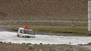 Four-wheel drive river crossing near India\'s frontier. 