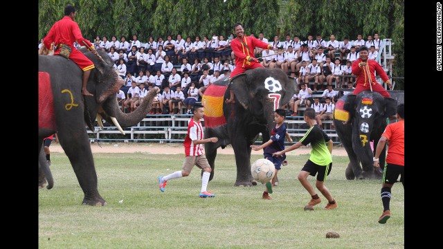 Thai Youth Go For The Ball During A Soccer Match Between People And