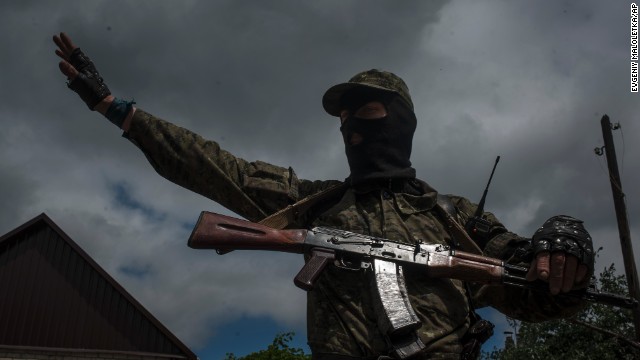 A pro-Russian fighter stands guard at a checkpoint in Slovyansk on June 12.