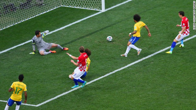 Brazil's Marcelo, second from right, accidentally deflects the ball past his own goalkeeper, Julio Cesar. It was the first goal of the tournament, and it put the host country in an early hole.