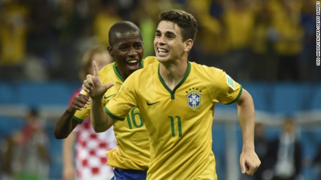 Brazilian midfielder Oscar, right, celebrates after scoring a late goal to give his team a 3-1 win over Croatia in the opening match of the World Cup on Thursday, June 12.