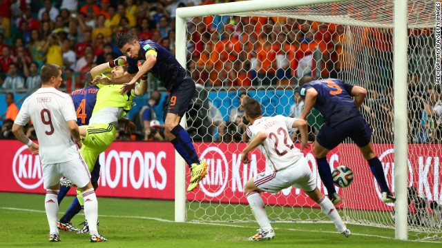 Stefan de Vrij, right, deflects the ball in for the Netherlands' third goal while van Persie collides with Spanish goalkeeper Iker Casillas.