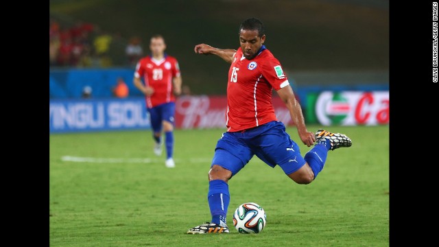 Jean Beausejour of Chile shoots and scores the final goal during his team's 3-1 win over Australia on Friday, June 13, in Cuiaba, Brazil.