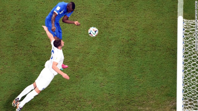 Italy striker Mario Balotelli, left, heads the winning goal against England on June 14. Italy defeated England 2-1 in Manaus, Brazil.