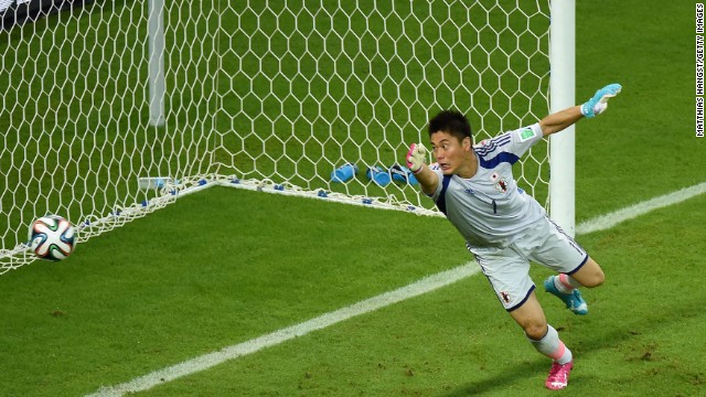 Japanese goalkeeper Eiji Kawashima tries in vain to stop a Wilfried Bony header from going in for Ivory Coast's first goal. 