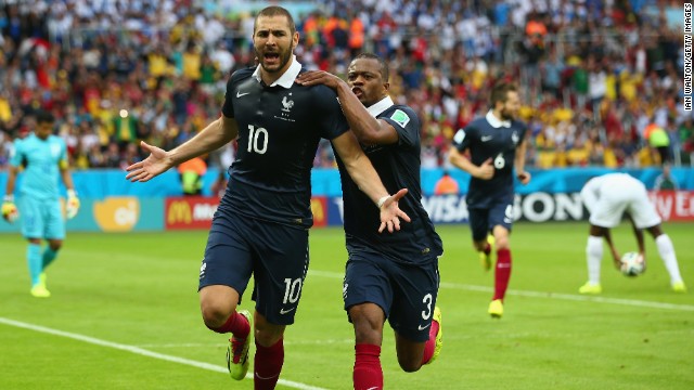 Benzema celebrates with Patrice Evra after scoring France's first goal against Honduras.