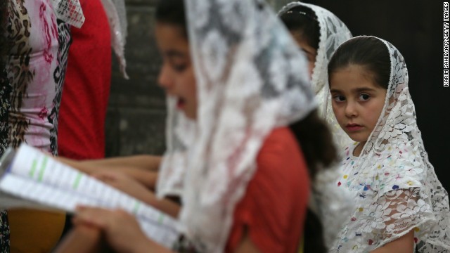 Iraqi Christian children gather inside the Church of the Virgin Mary for prayers in Bartala, Iraq, a town near Mosul, on Sunday, June 15. Militants seized Mosul last week, reportedly leading more than 500,000 people to flee Iraq's second-largest city.