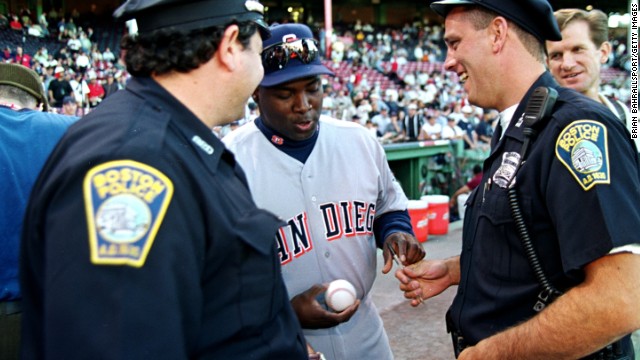 Gwynn signs a baseball for two police officers before the 1999 All-Star Game. Gwynn made the All-Star team in 15 of his 20 seasons.