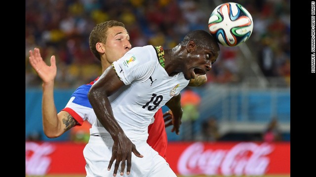 Ghana defender Jonathan Mensah heads the ball in front of Johnson.