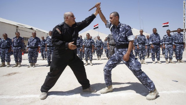 Newly recruited Iraqi volunteer fighters take part in a training session in Karbala, Iraq, on June 17.