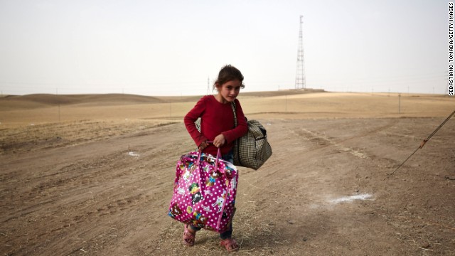 A girl fleeing from Mosul arrives at a Kurdish checkpoint on June 12.