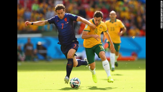 Daryl Janmaat of the Netherlands, left, fights off Tommy Oar of Australia. 