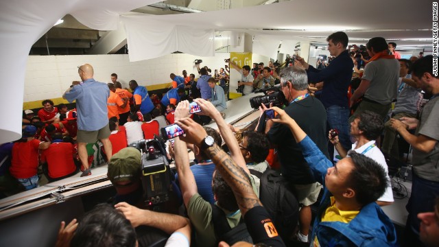 Security personnel attempt to control Chilean fans who <a href='http://bleacherreport.com/articles/2101732-chile-fans-break-into-maracana-press-room-before-world-cup-match-vs-spain' target='_blank'>invaded the press room</a> at the Maracana Stadium before the match.