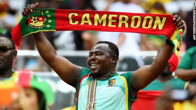 A Cameroon fan shows his support before the game.