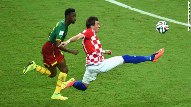 Mario Mandzukic of Croatia competes for the ball with Nicolas N'Koulou of Cameroon.