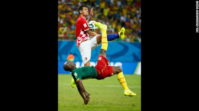 Pierre Webo of Cameroon attempts an overhead kick against Croatia's Dejan Lovren.