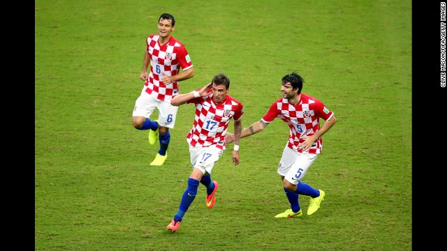 Mandzukic, center, celebrates scoring Croatia's third goal with his teammates Dejan Lovren, left, and Vedran Corluka.