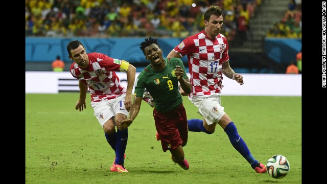 Croatia's Darijo Srna, left, and Mario Mandzukic tackle Cameroon's Benjamin Moukandjo. 