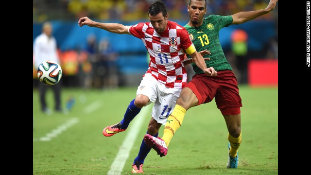 Cameroon's Eric Maxim Choupo-Moting, right tackles Croatia's Darijo Srna during a World Cup match in Manaus, Brazil, on Wednesday, June 18. Croatia won 4-0.