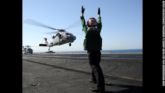 An MH-60R Sea Hawk helicopter lands on the aircraft carrier USS George H.W. Bush in the Persian Gulf on Tuesday, June 17. The carrier moved into the region to give President Barack Obama <a href='http://www.cnn.com/2014/06/14/world/meast/iraq-violence/'>"additional flexibility," the Pentagon</a> has said.