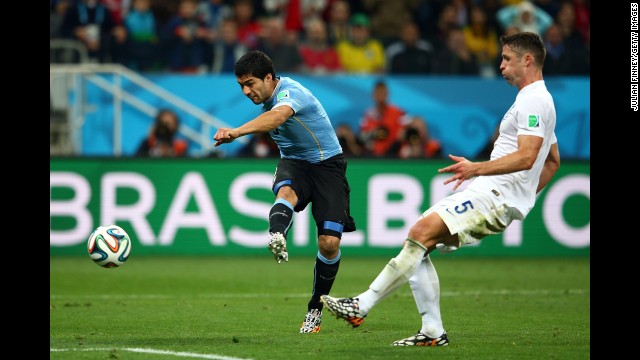 Uruguayan forward Luis Suarez drills a shot to score a late second-half goal and defeat England 2-1 in a World Cup match Thursday, June 19, in Sao Paulo, Brazil. Suarez had both of Uruguay's goals. 