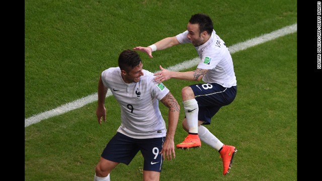 France midfielder Mathieu Valbuena, right, jumps on Giroud's back after Giroud assisted on his first-half goal.