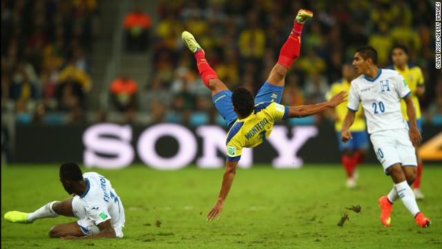 Jefferson Montero of Ecuador falls after a challenge by Maynor Figueroa of Honduras.