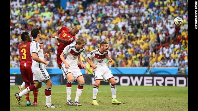 Andre Ayew of Ghana scores his team's first goal on a header over Per Mertesacker and Shkodran Mustafi of Germany.