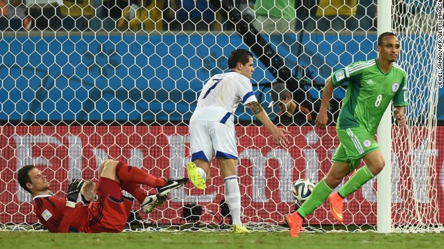 Nigeria forward Peter Odemwingie, right, shoots past Bosnia-Herzegovina goalkeeper Asmir Begovic, left, on Saturday, June 21, in Cuiaba, Brazil. Nigeria won 1-0.
