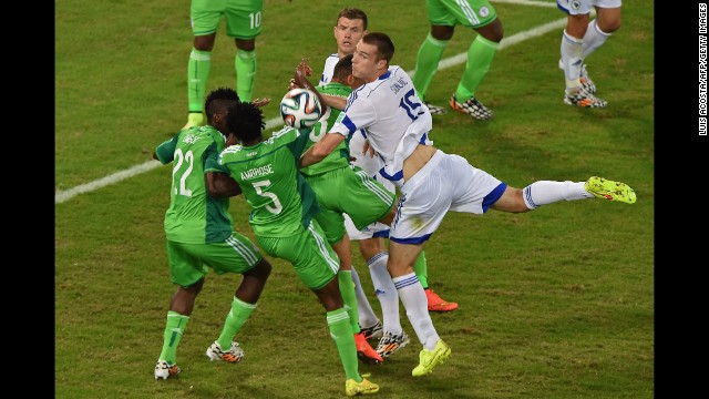 Bosnia defender Toni Sunjic, right, fights for the ball with Nigeria defender Kenneth Omeruo, left, Nigeria defender Efe Ambrose and Nigeria forward Peter Odemwingie, center.