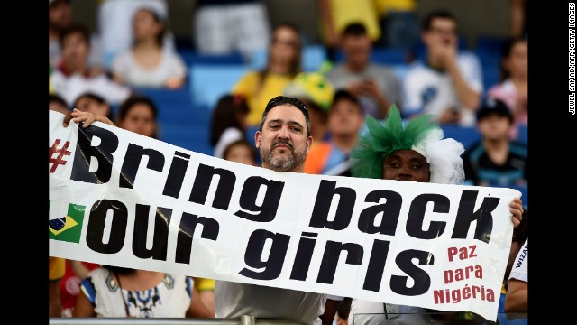 A man holds a banner reading "Bring back our girls" ahead of the match between Nigeria and Bosnia-Herzegovina. The sign is a reference to the abduction of more than 200 Nigerian schoolgirls in April.