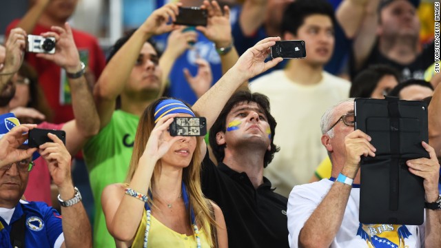 Fans snap photos during the match between Nigeria and Bosnia-Herzegovina. 