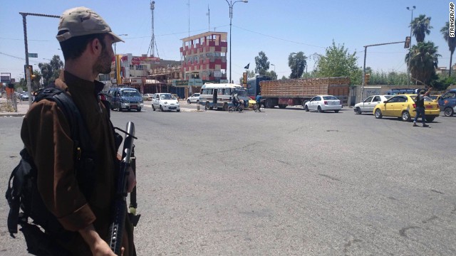 An ISIS fighter takes control of a traffic intersection in Mosul on Sunday, June 22. 