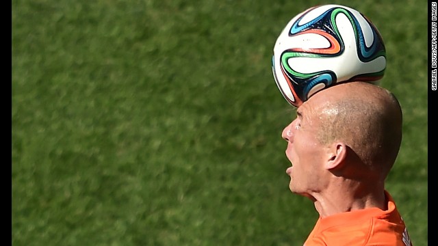 Netherlands forward Robben heads the ball.