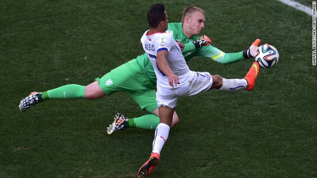 Chile forward Alexis Sanchez, front, competes for the ball with Netherlands goalkeeper Jasper Cillessen.