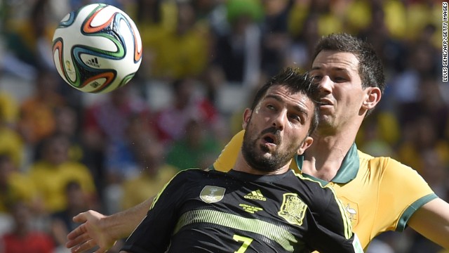 Spain forward David Villa, front, in action against Australia defender Ryan McGowan.