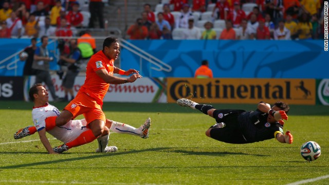 Memphis Depay of the Netherlands scores his team's second goal past Chile's goalkeeper Claudio Bravo in Sao Paulo on June 23. Netherlands won 2-0.