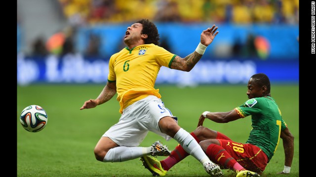 Brazil's Marcelo, left, is challenged by Enoh Eyong of Cameroon.