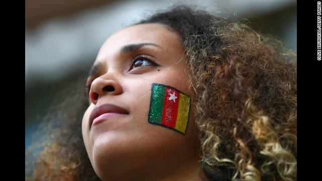 A fan sports a Cameroon flag painted on her face during the match against Brazil.