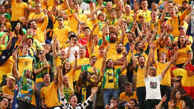 Australian fans cheer during the match against Spain at Arena da Baixada.