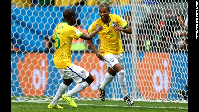 Fernandinho, right, of Brazil celebrates scoring his team's fourth goal with teammate Ramires.